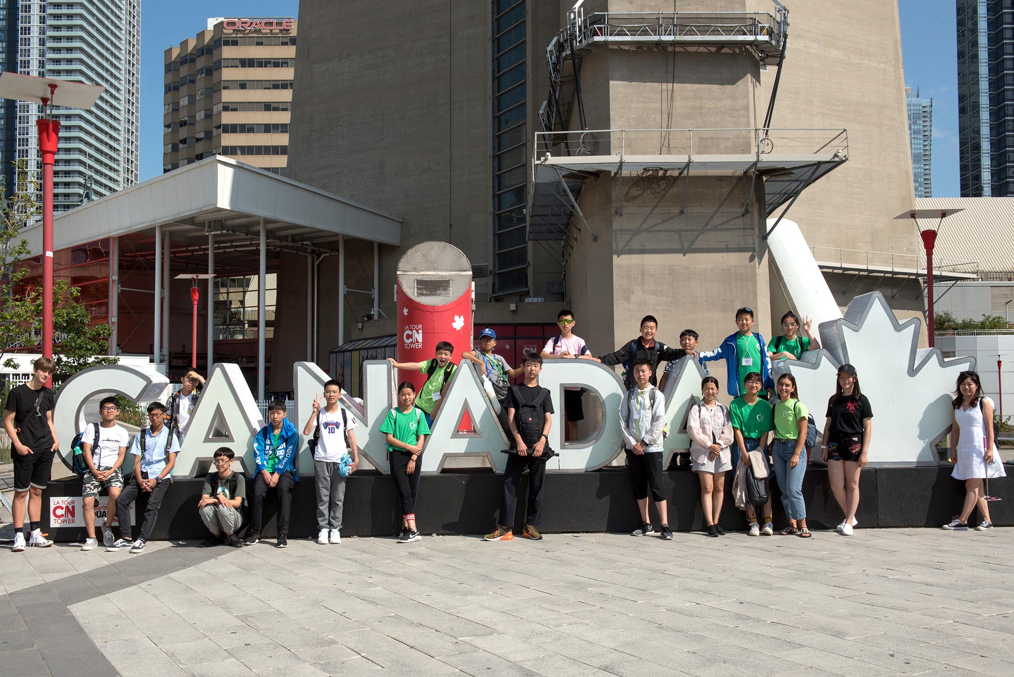Students standing in front of CANADA sign in Toronto Open Gallery